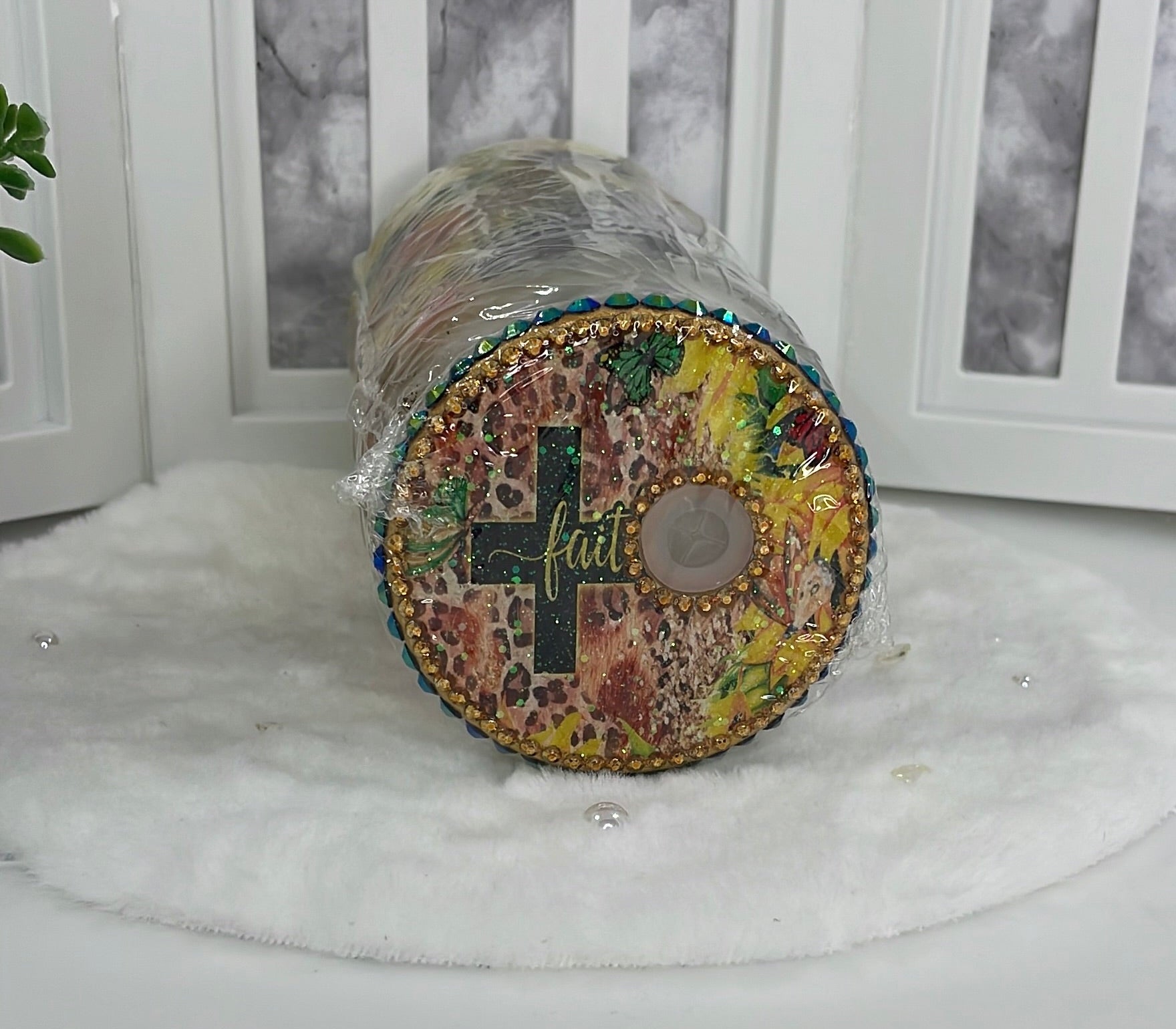Decorative cylindrical object with multicolored pattern on a white surface
